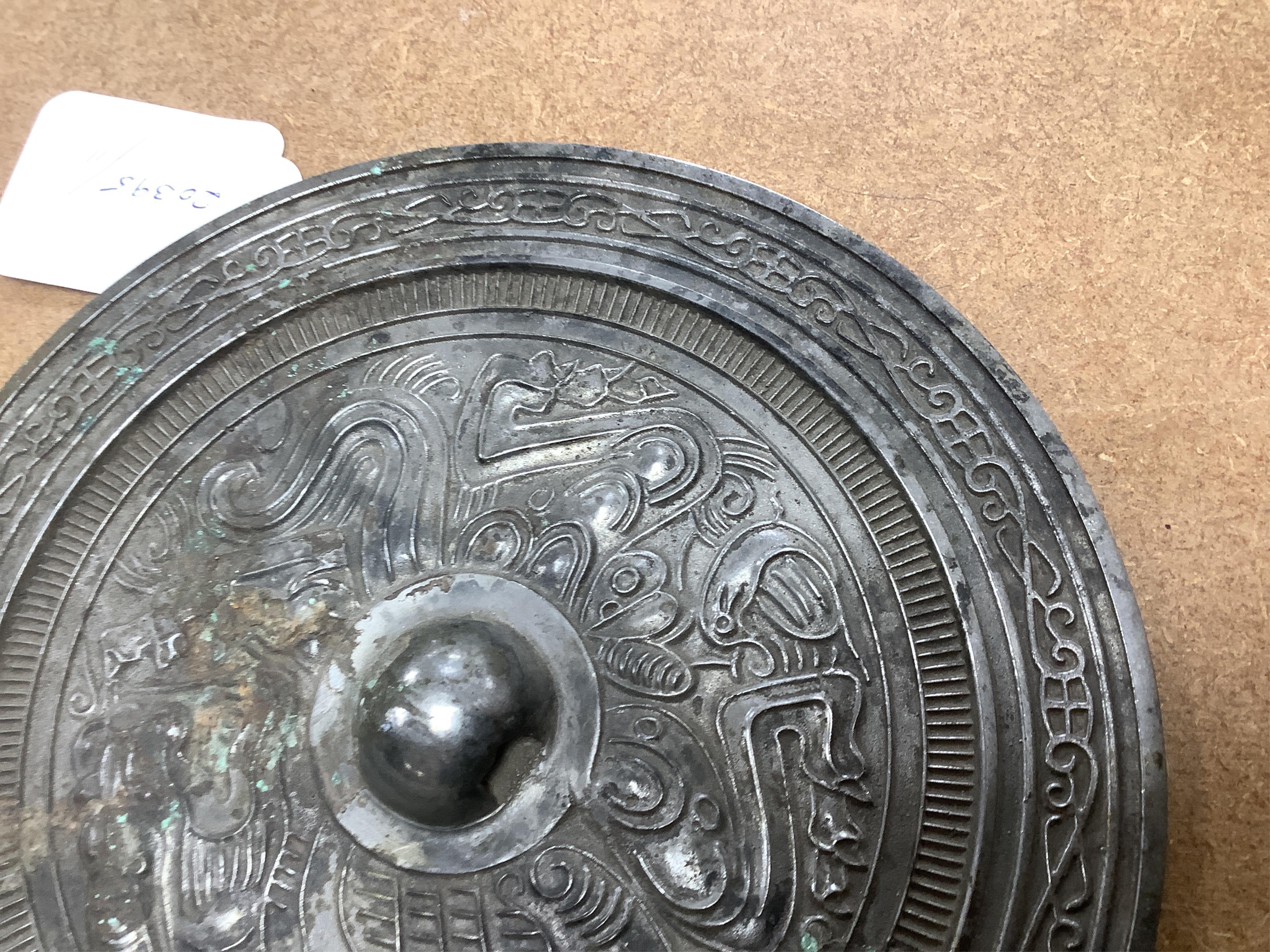 Chinese bronze ‘dragon’ mirror back, 19cm in diameter